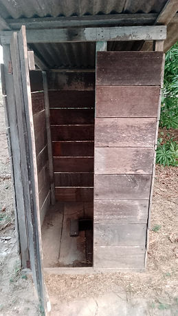 An outhouse, "restroom", used by students in the Amazon jungle. Notice that there is nowhere to sit.