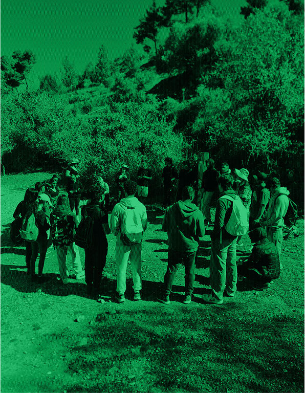 highschool students standing in a circle in the nature