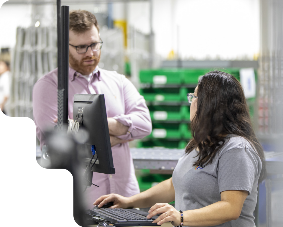 Colleagues collaborating on computer in Spoke facility