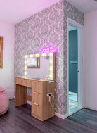 Wallcovering, decor, and makeup vanity donated by Tolin Designs.