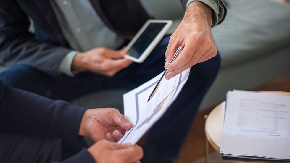 Close-up of two business professionals discussing documents in a meeting.