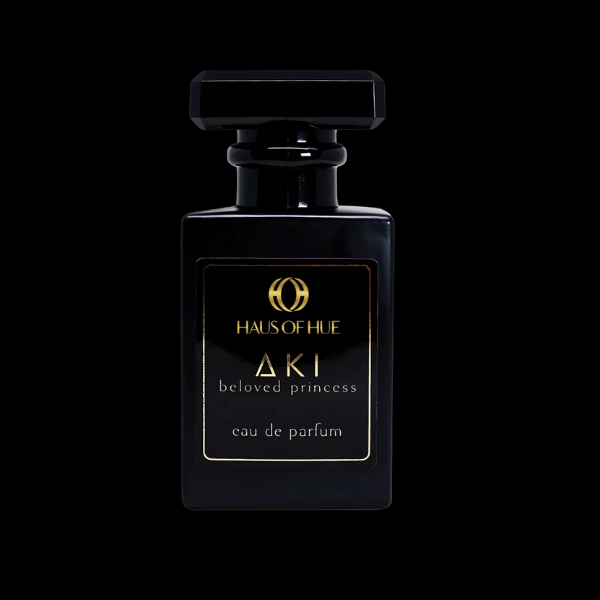 A luxurious black perfume bottle with gold accents, labeled 'Haus of Hue AKI Beloved Princess Eau de Parfum,' isolated on a black background.