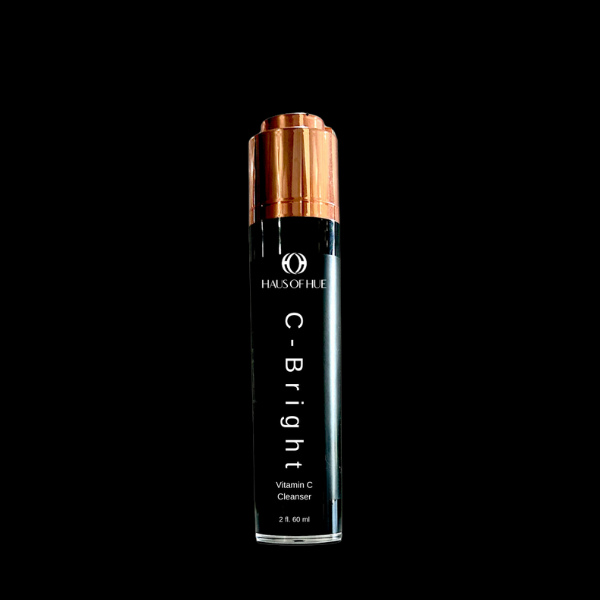 A sleek black bottle labeled "HAUS OF HUE C-Bright Vitamin C Cleanser," featuring a copper cap. The product is set against a solid black background, highlighting a modern and premium skincare design.