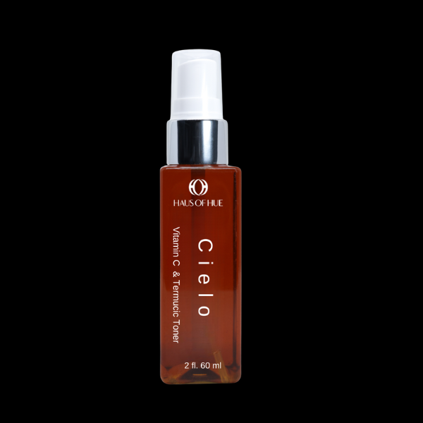 A sleek amber bottle labeled "HAUS OF HUE Cielo Vitamin C & Ferulic Toner," featuring a silver pump cap. The product is set against a dark background, emphasizing its modern and elegant design.