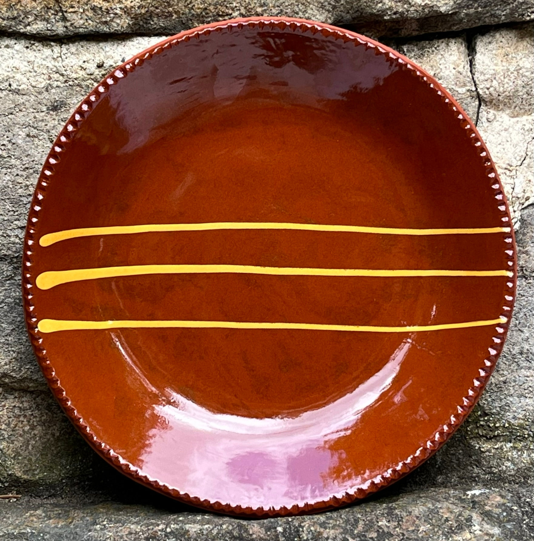 Slipware plate decorated with the slip-trailing method as the Pennsylvania German Potters did on their pottery