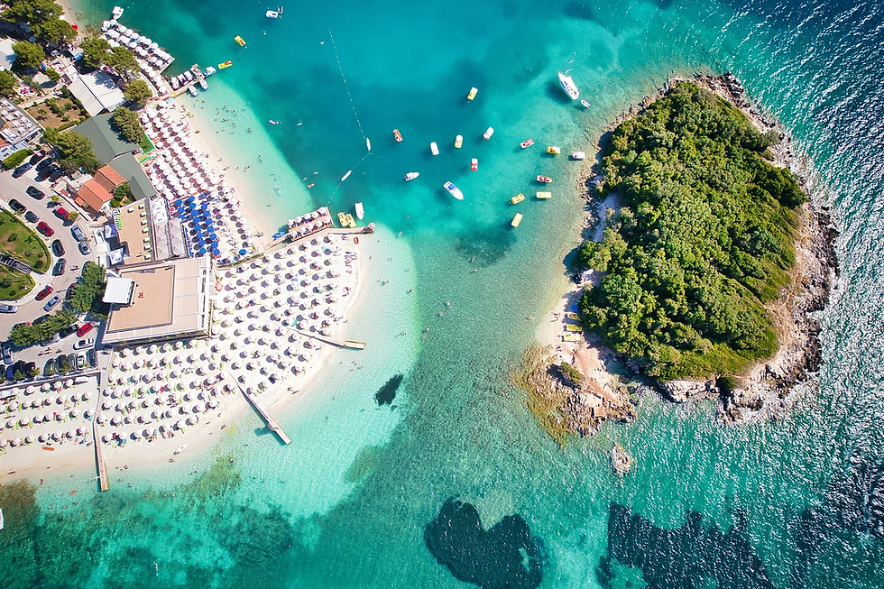 Beach umbrellas on the white sand of Ksamil