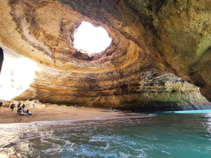Benagil Cave with turquoise water visible through the hole in the ceiling