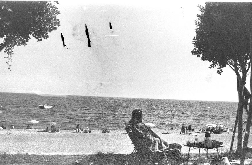 man sitting in chair on a beach