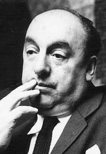 Poet Pablo Neruda holds his hand to his lips while looking away, wearing a suit and tie.