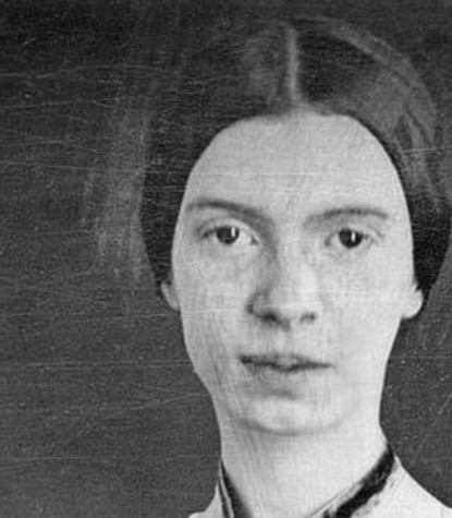 A portrait in black and white of poet Emily Dickinson, with her hair neatly pulled back in a bun.