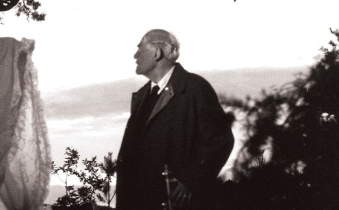 Victor Sjöström (Dr. Isak Borg) looks into the distance, standing under the branches of a tree in Ingmar Bergman's film Wild Strawberries.