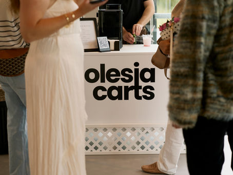 Event cart with large Olesia Carts branding on the front, staffed indoors.