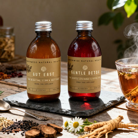 Bottles labeled "Hormone Harmony" and "Calm Nerve" on plate with herbs, a glass of red beverage with fruit, on rustic table, sunny ambiance.