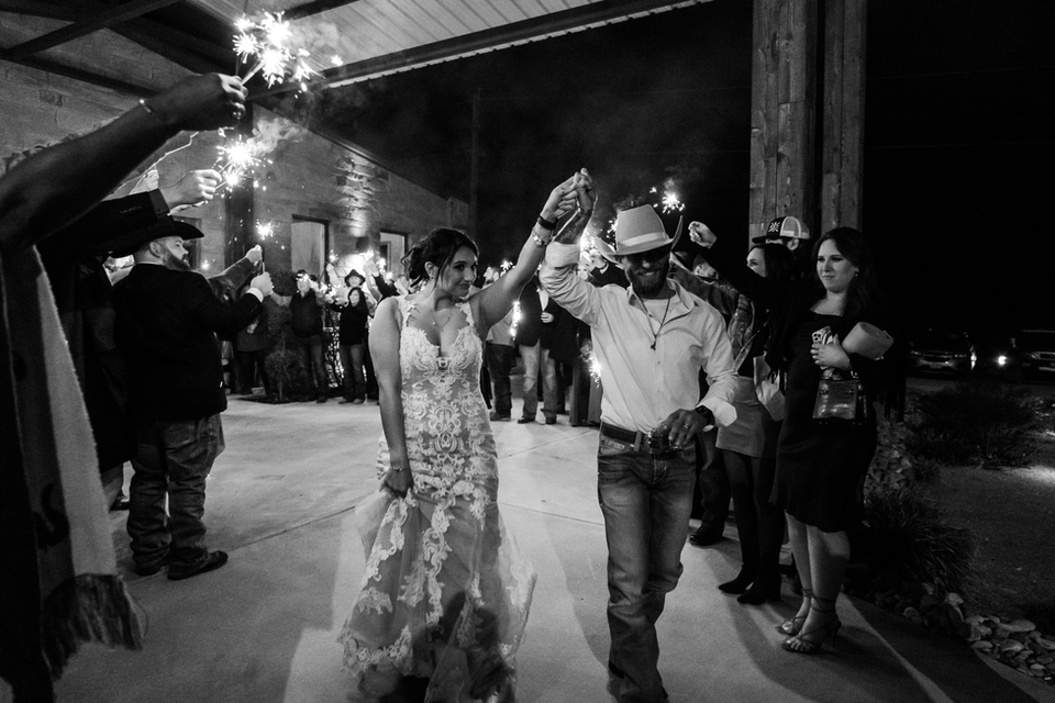 The bride and groom making their exit through sparklers.