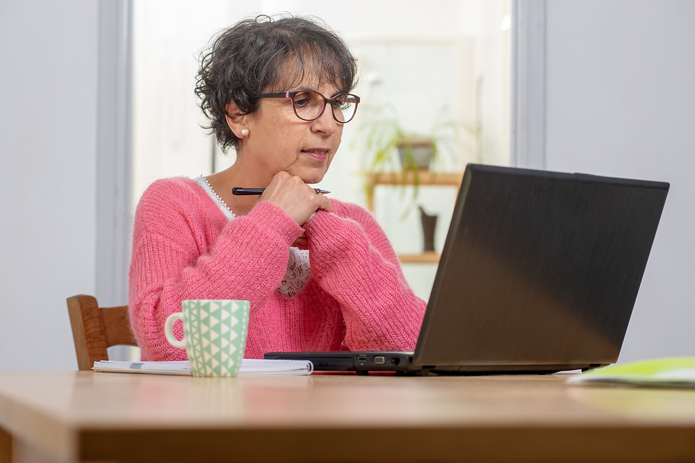 Woman sitting in front of laptop