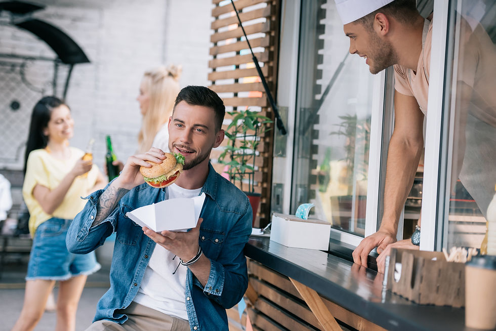 Man eating burger from shop.