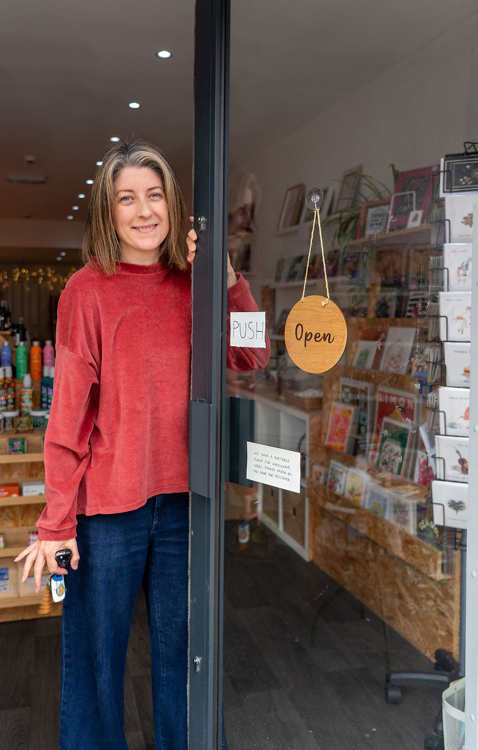 Jessica from Waste Less Shop opening the shop door
