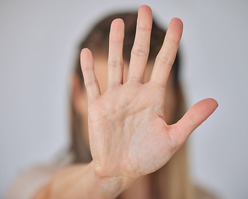 Abuse, hand and stop with victim person in studio on gray background for awareness or conf