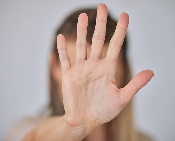 Abuse, hand and stop with victim person in studio on gray background for awareness or conf