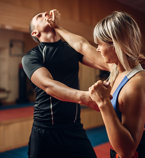 Female person on self-defense workout with trainer.jpg