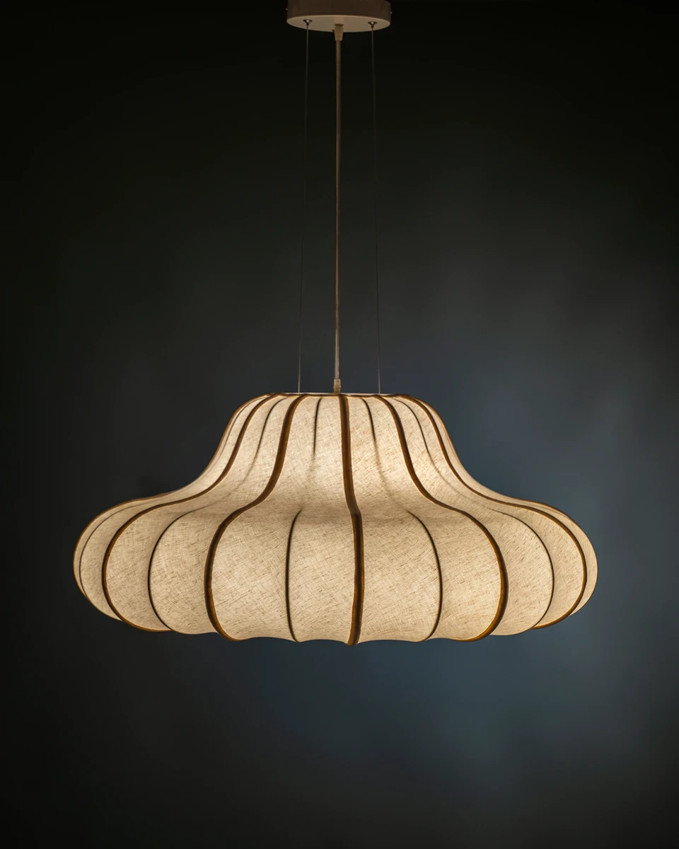 Front view of the illuminated ORBIT dining chandelier, casting a soft warm glow perfect for upscale living areas.