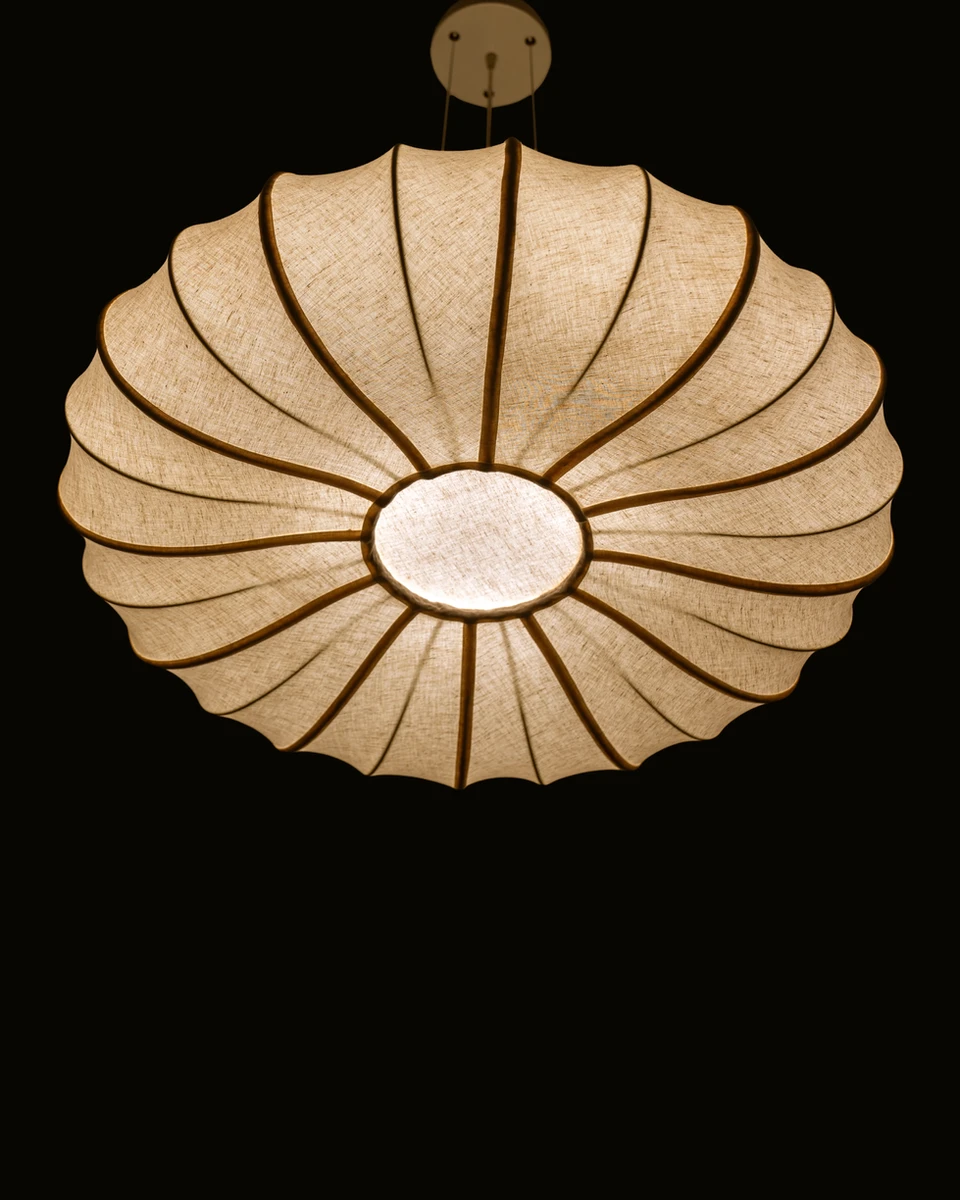 Underneath view of the lit ORBIT sculptural ceiling light by Name Place Animal Thing , perfect for dining rooms.