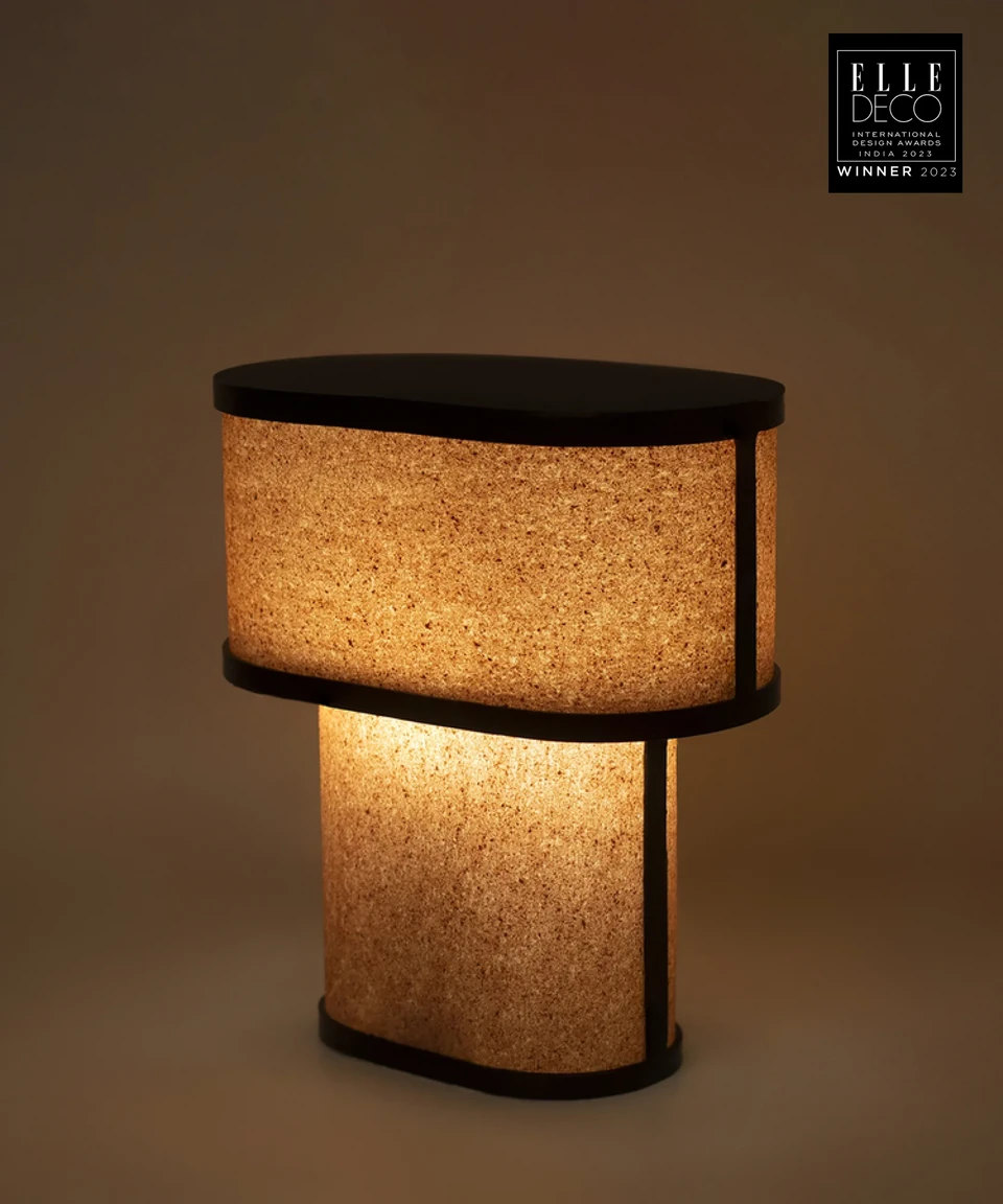 NIKO Table Lamp showcasing natural red sandstone textures, warm lighting, and modern luxury design