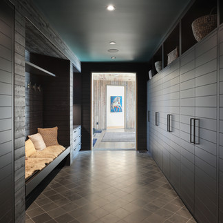 Walkway painted dark charcoal color with storage connecting spaces at Rivers Edge home