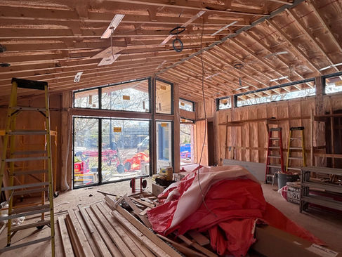 Interior of Ottawa renovation at framing stage showing Marvin Ultimate front glazing and exposed roof structure