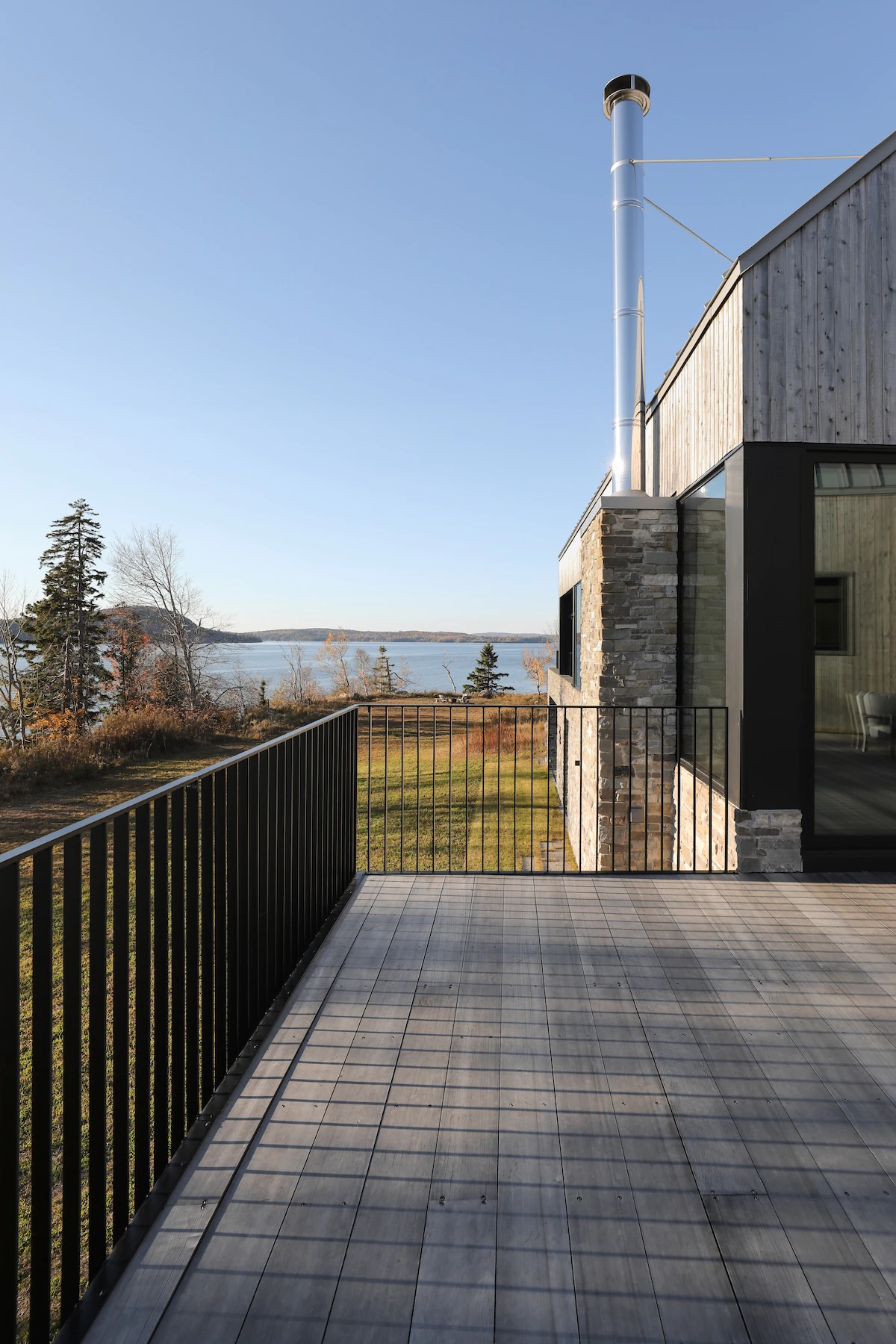View along rear of home from primary bedroom patio showing the view and chimney