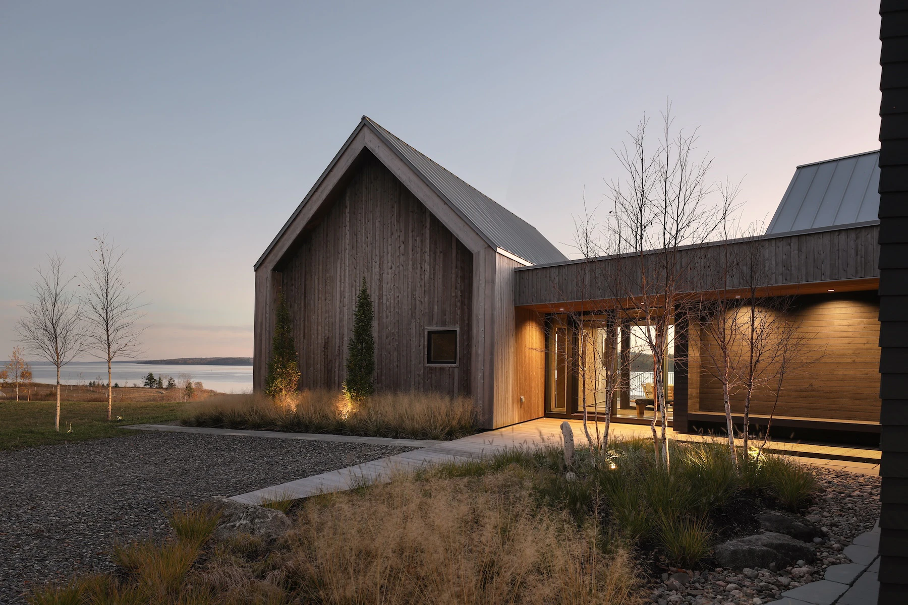 Main entrance at Rivers Edge home featuring a glass lined breezeway connecting the main living area to the primary bedroom