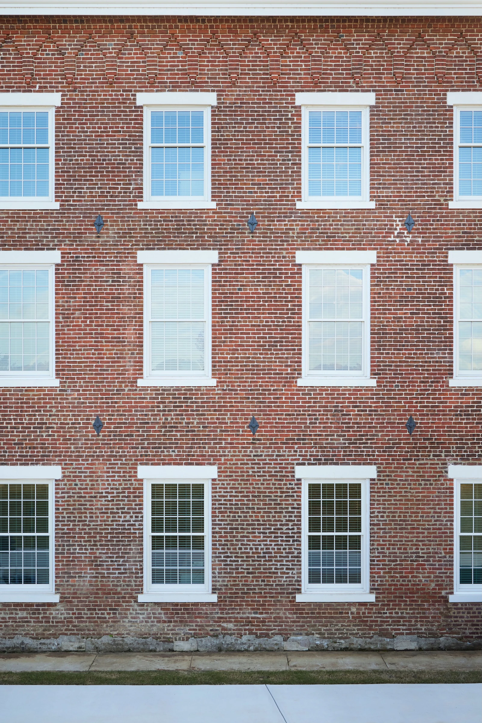 Exterior view of historic brick building next to water that has been converted to condos