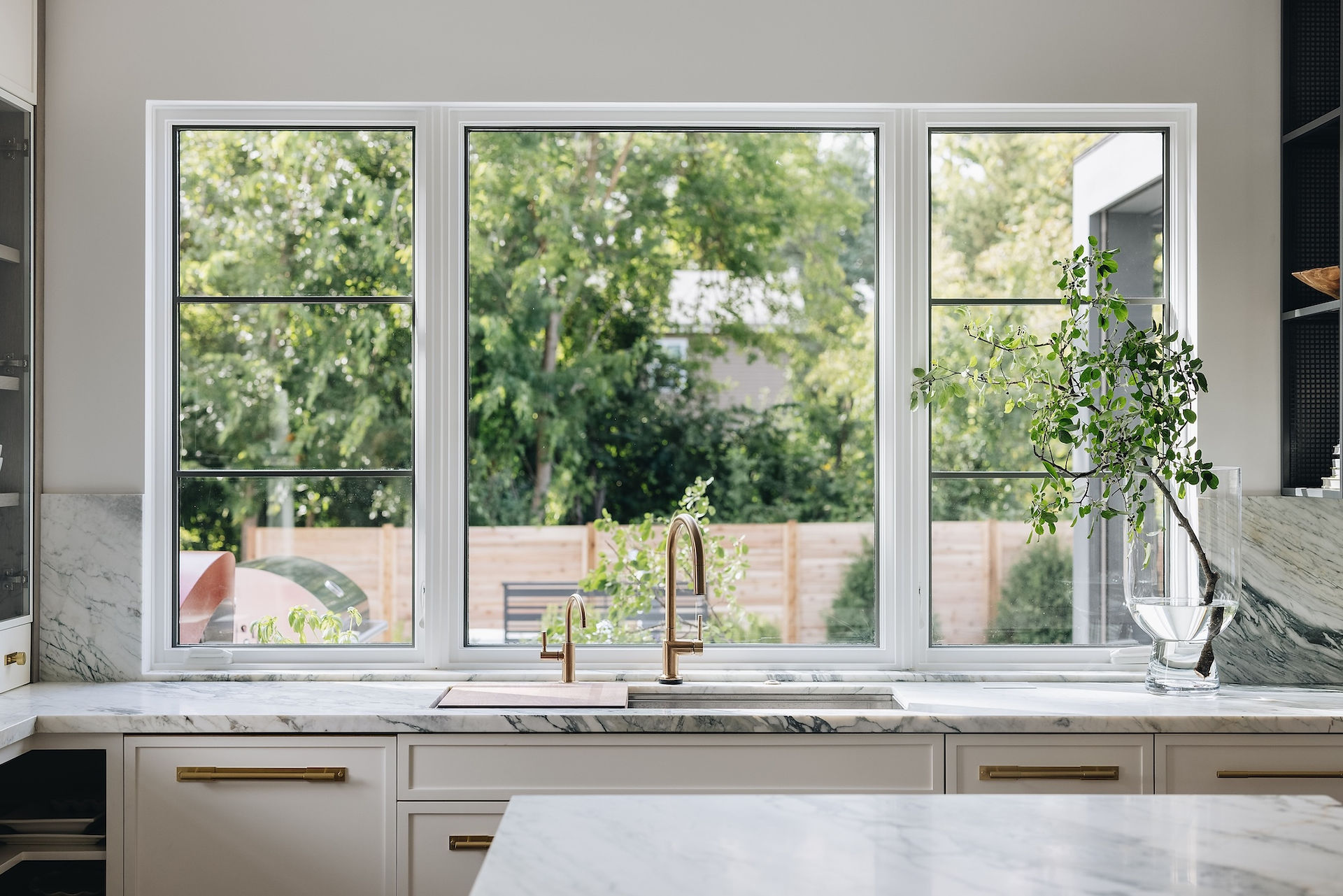 Picture and flanker casement windows in a Canadian kitchen maximizing ventilation and light
