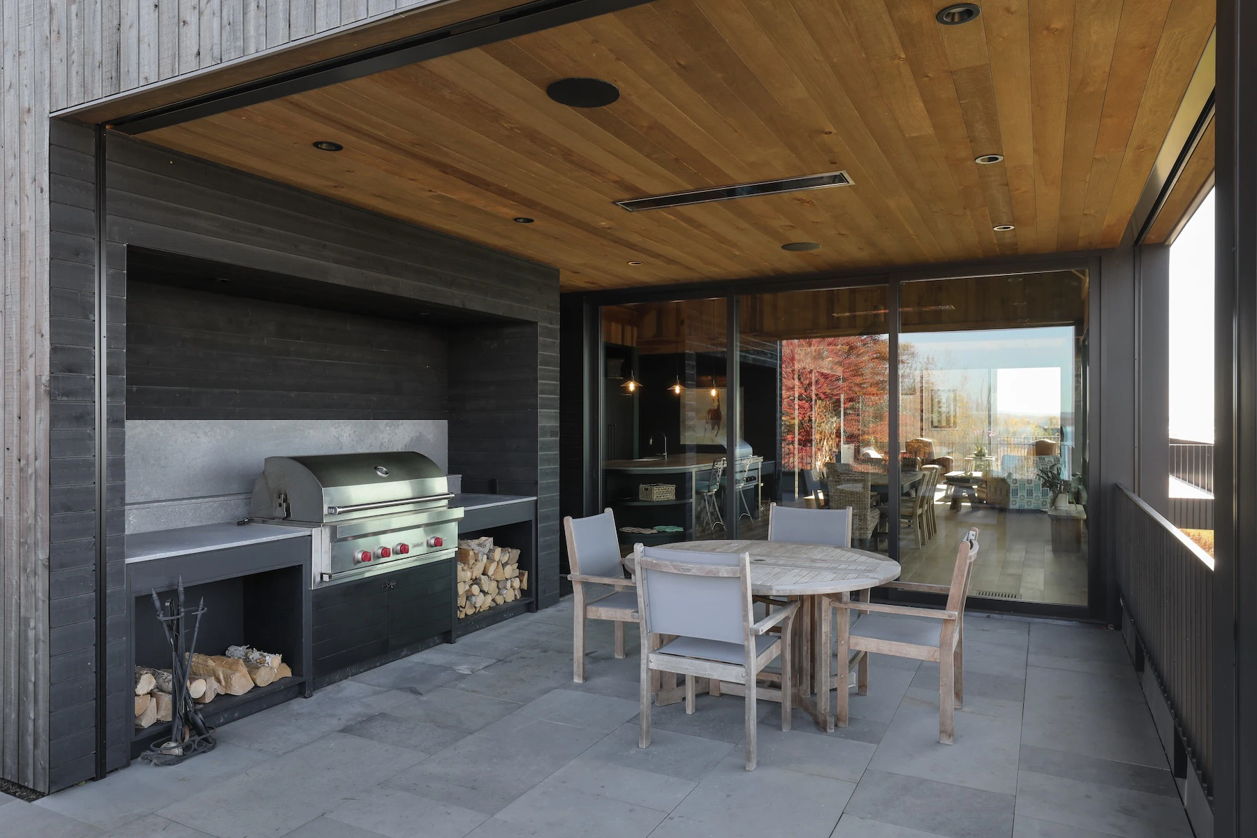 Covered outdoor dining and entertaining area with BBQ and large multi slide Marvin door