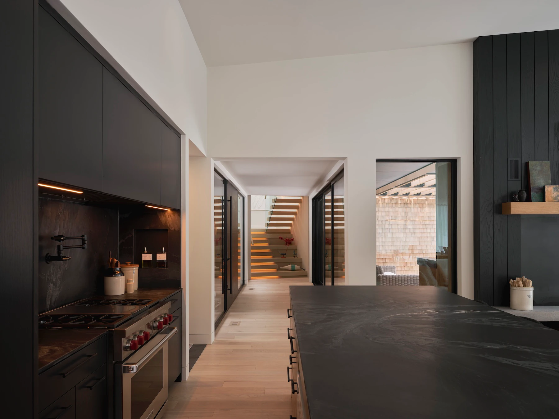 Sunnybrook sanctuary custom home interior view through the kitchen towards the entry door and staircase to bedrooms