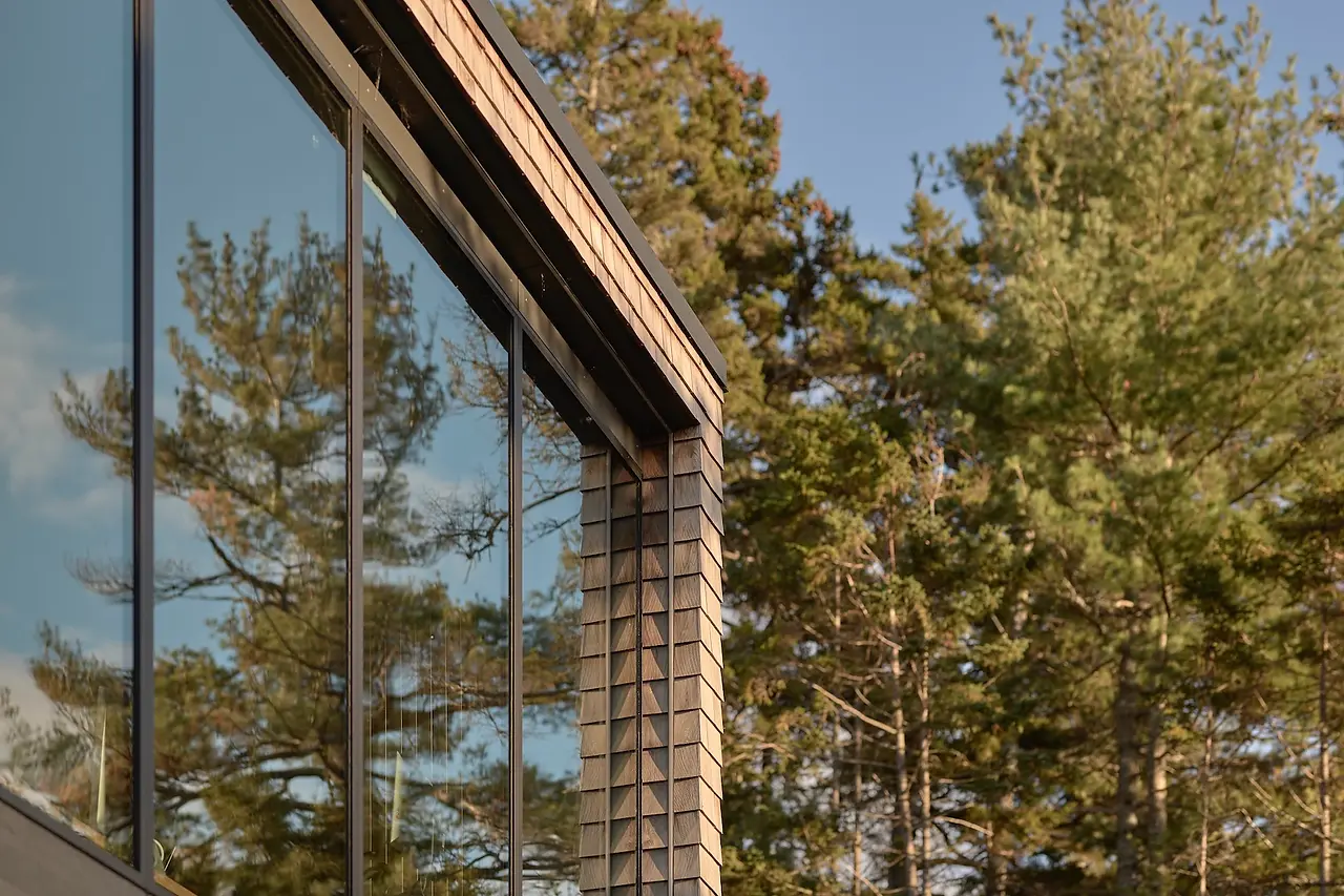 Sunnybrook Sanctuary custom home exterior close up of Marvin picture windows and cedar siding surround
