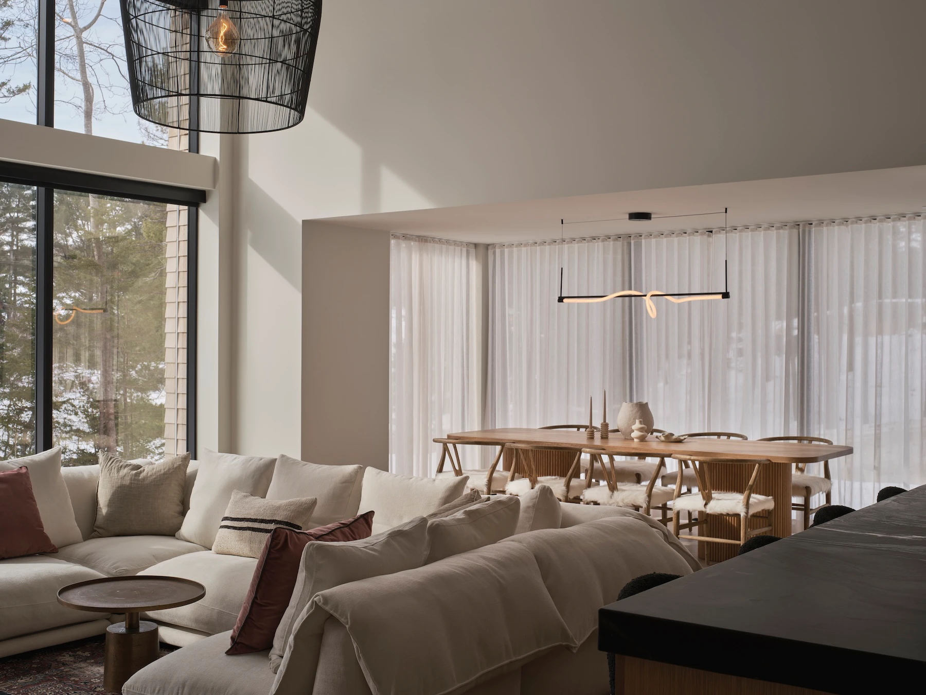Sunnybrook sanctuary custom home interior living and dining room with bright sunlight filtering in through the window wall