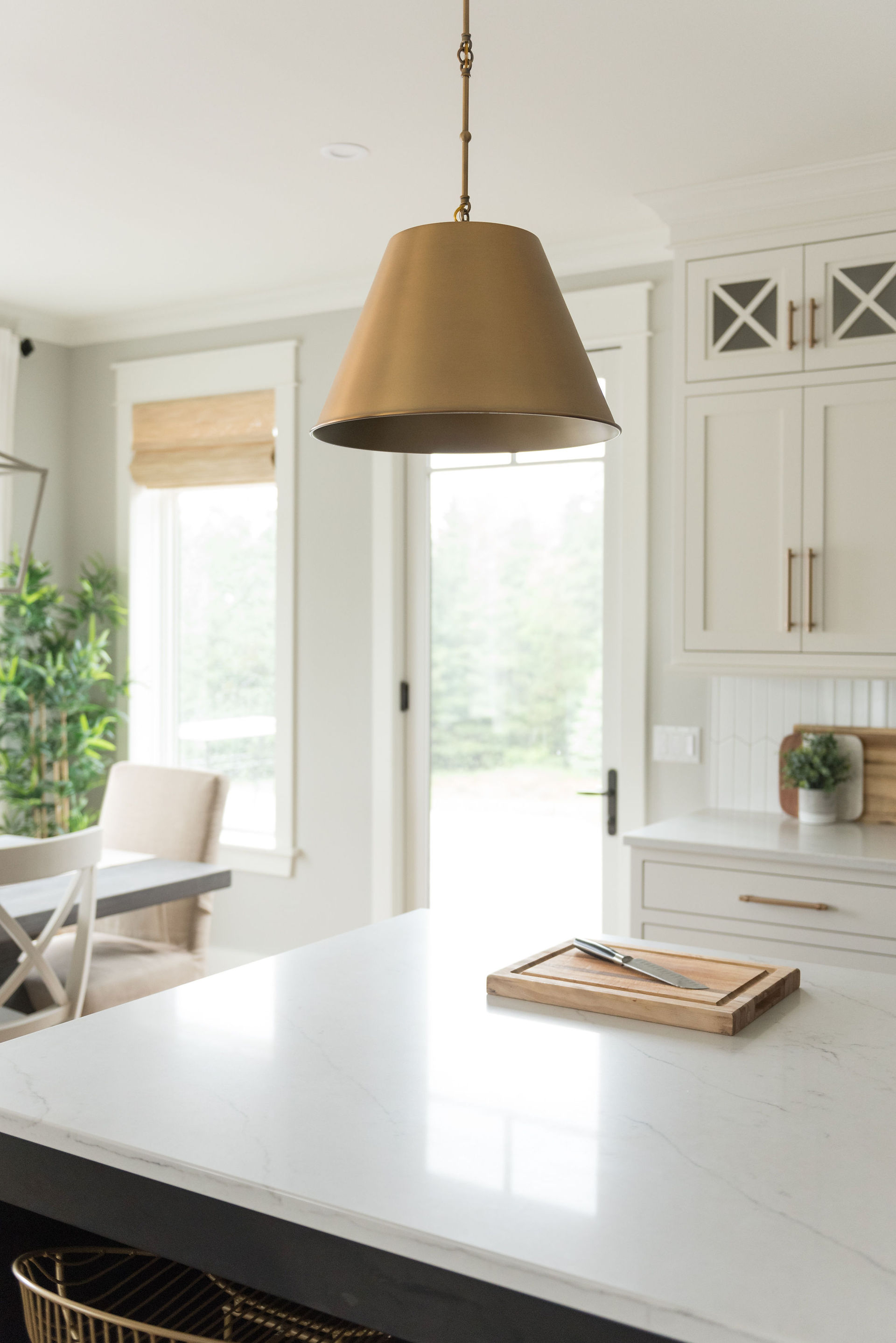 detail shot of island and pendant lighting, with Marvin Swinging Patio Door in the background