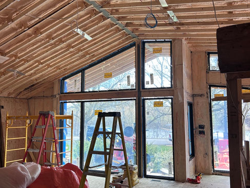 Interior of Ottawa renovation at framing stage showing Marvin Ultimate front glazing and exposed roof structure