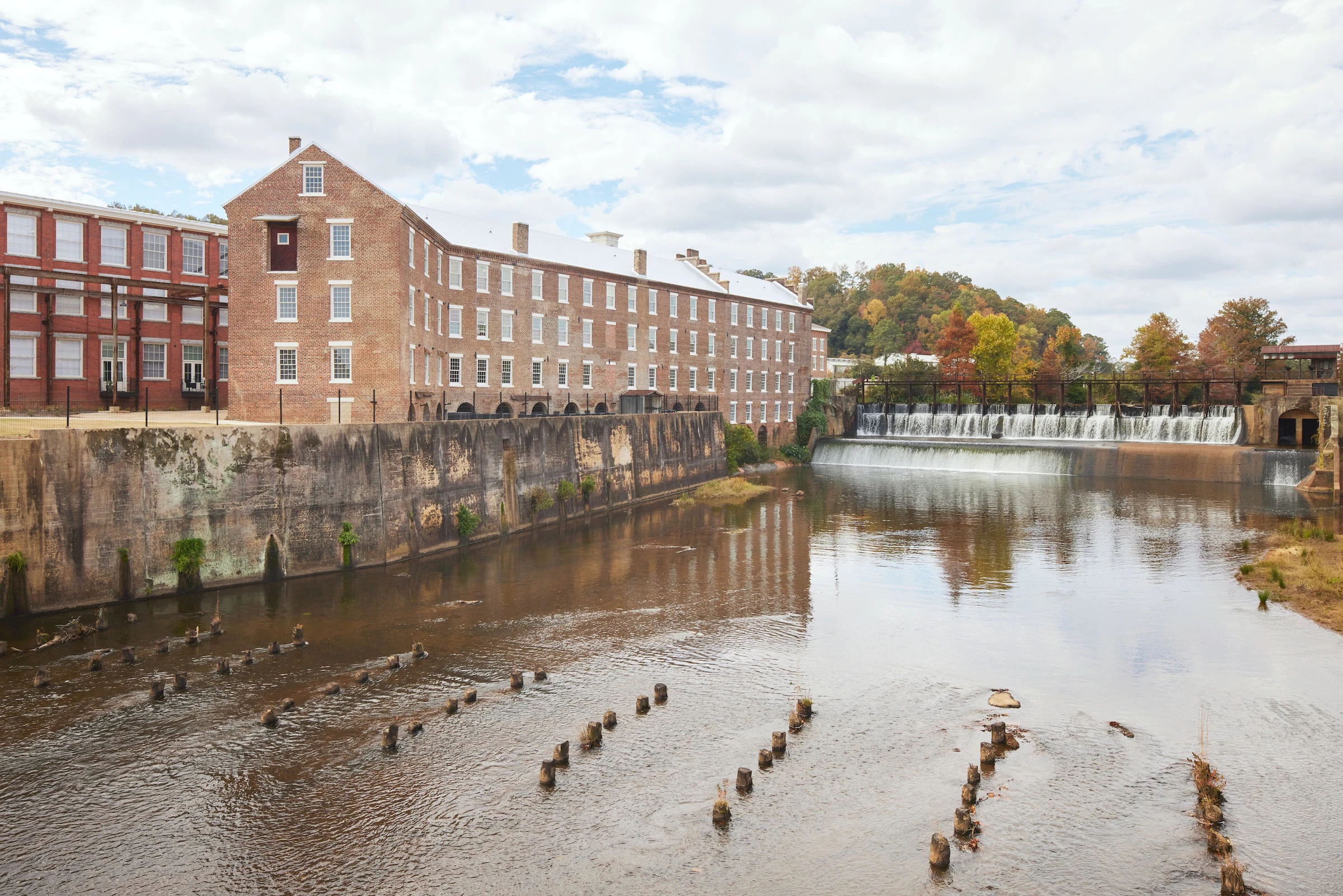 Exterior view of historic brick building next to water that has been converted to condos