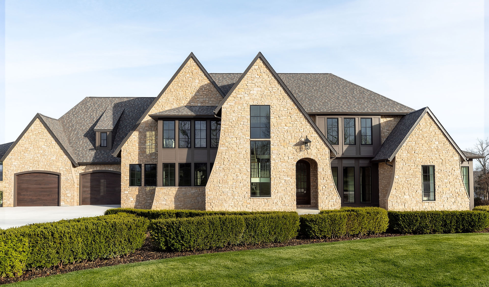 Modern brick masonry home featuring black windows by Marvin