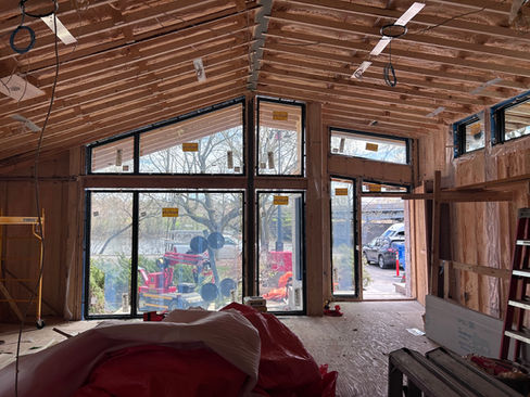 Interior of Ottawa renovation at framing stage showing Marvin Ultimate front glazing and exposed roof structure