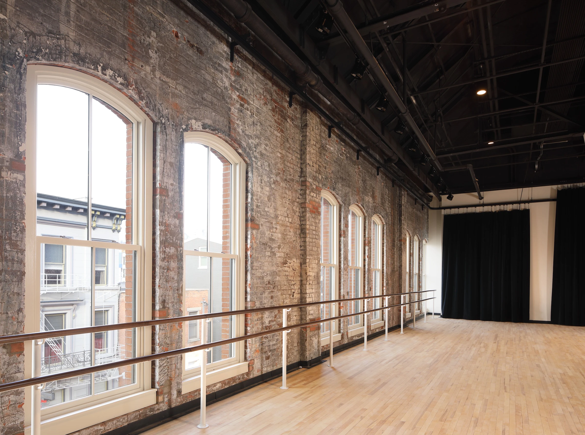 Interior of historic brick building next to water that has been converted to condos and a dance studio