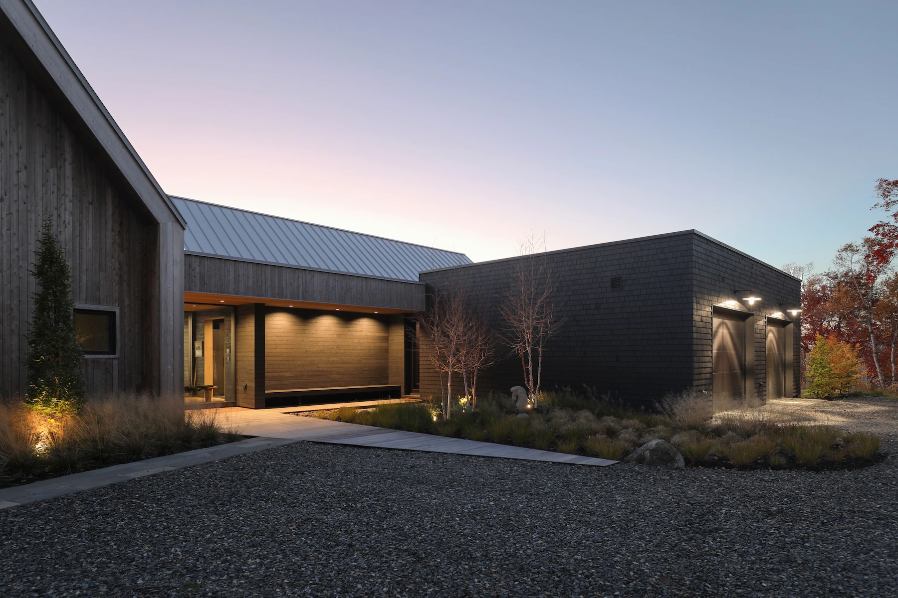 Front of home at twilight with lights on at Rivers Edge in New Brunswick