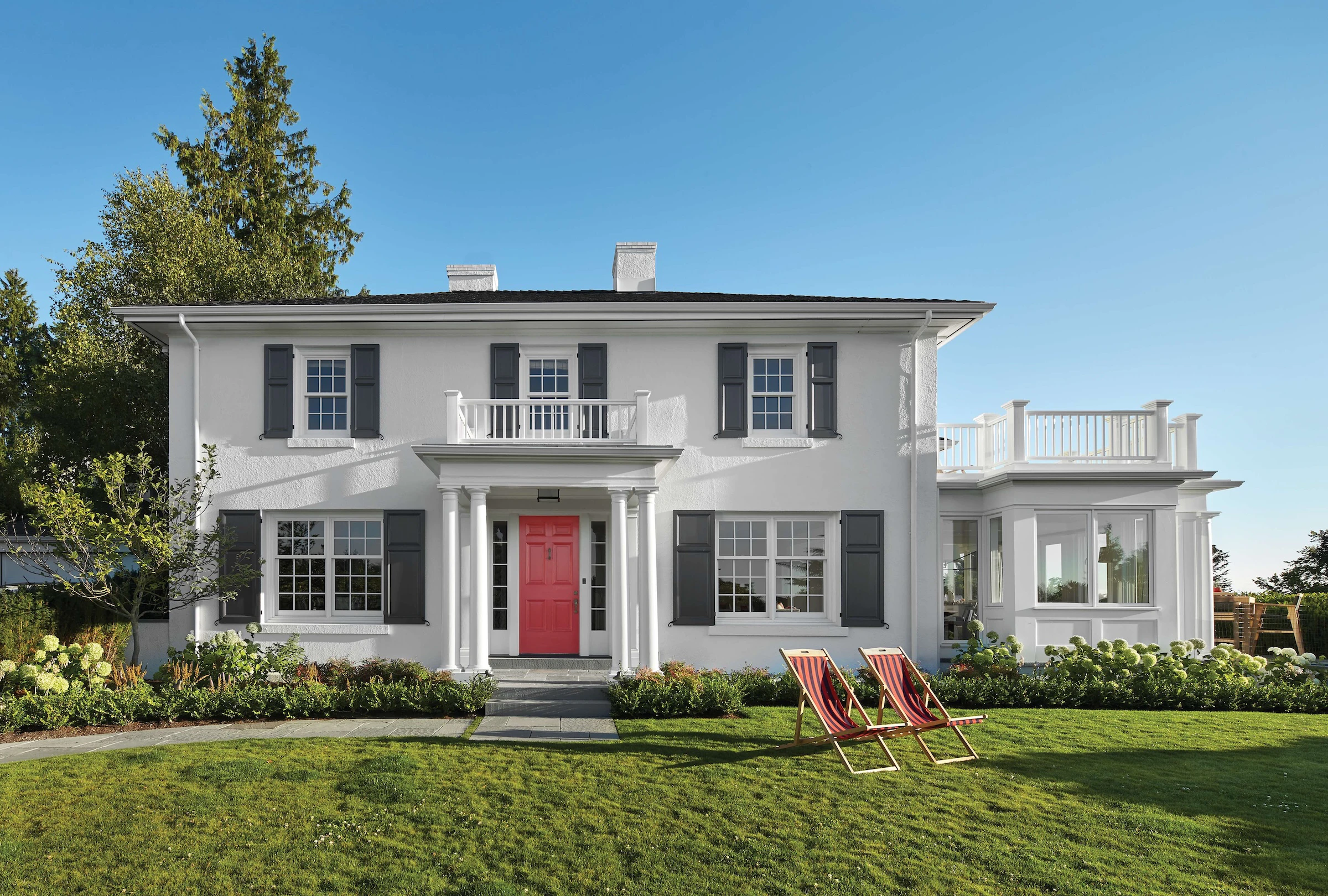 Renovated historic home with replacement Marvin windows and red entry door