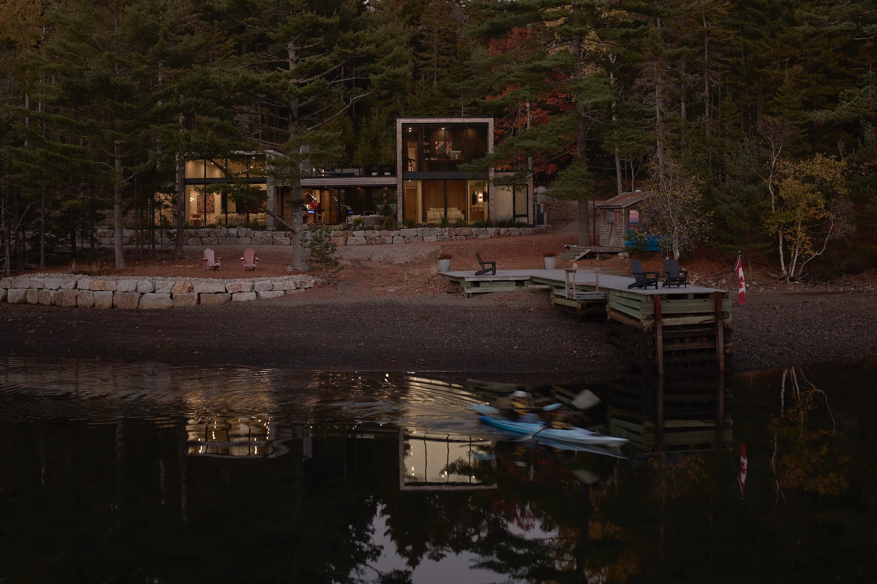 Sunnybrook sanctuary custom home exterior view at dusk, loooking across the water