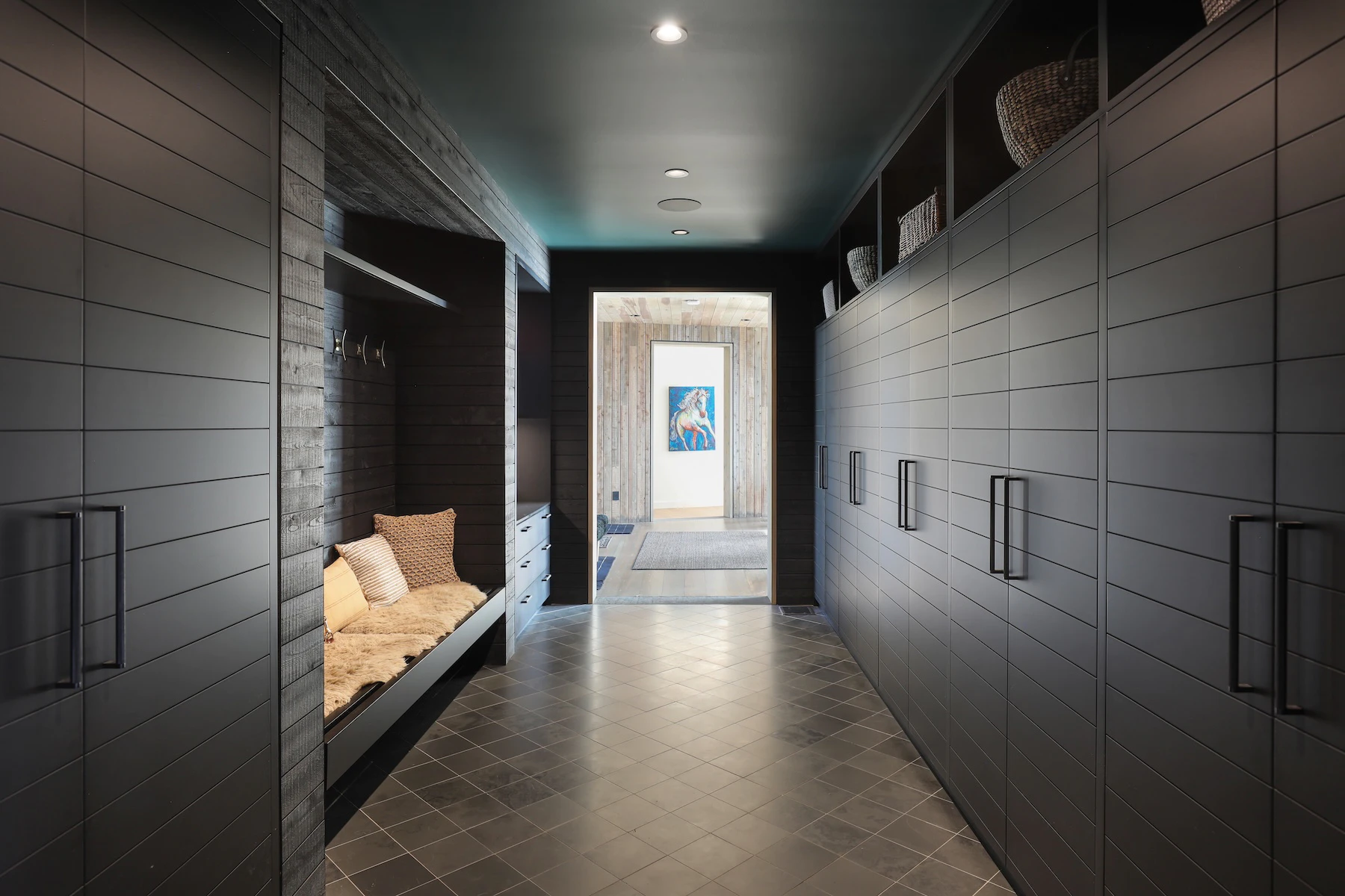 Walkway painted dark charcoal color with storage connecting spaces at Rivers Edge home