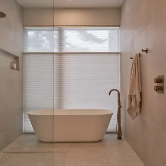 Sunnybrook sanctuary custom home interior bathtub placed inside a wet room, set in front of a large shaded privacy window