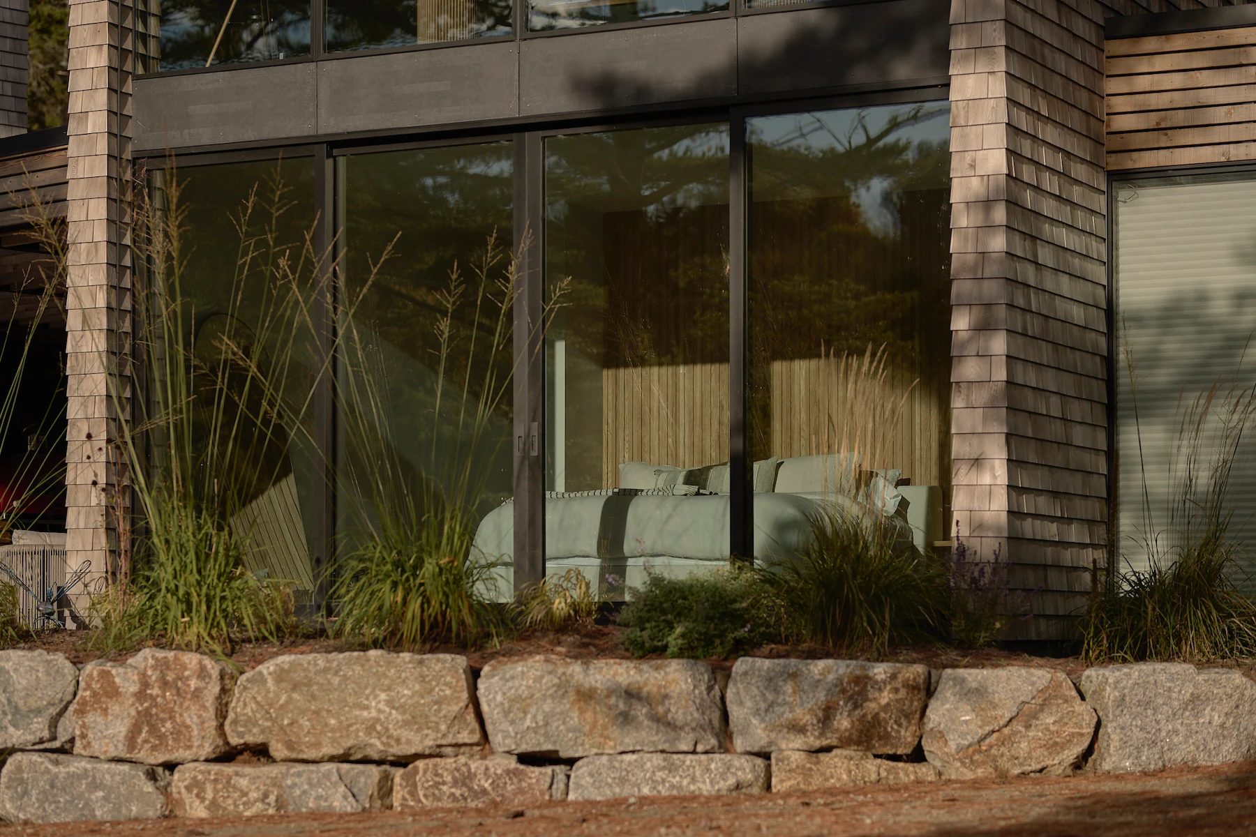 Sunnybrook sanctuary custom home exterior view looking through bedroom window on a sunny day