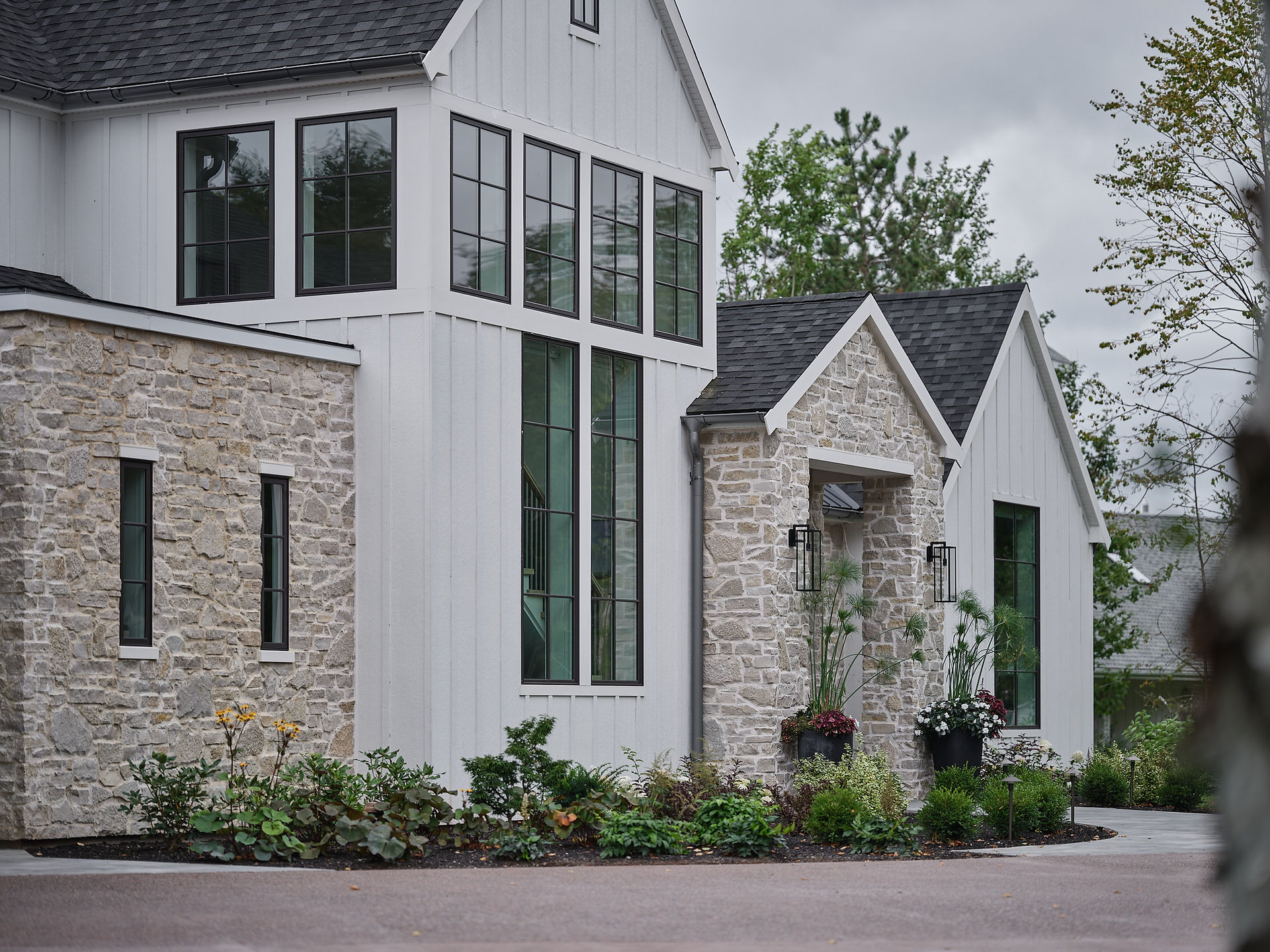 Exterior view of Battery Point Retreat waterfront home with bronze-framed Marvin Elevate windows overlooking the ocean